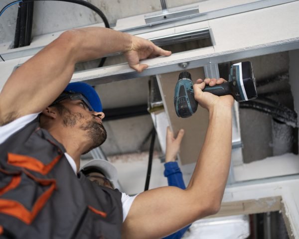 low-angle-people-working-with-drill